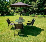 Table de jardin avec 4 chaises et un parasol acier et plateau verre trempé à 129,99 € dans le catalogue Maxi Bazar
